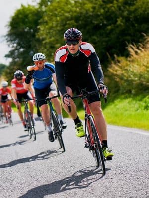 Cyclists at UCI START line with scenic background