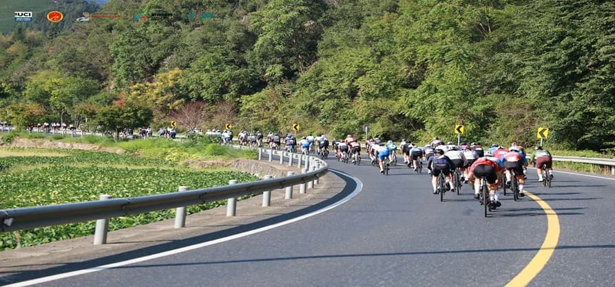 Cyclists on scenic road during UCI Gran Fondo Hangzhou